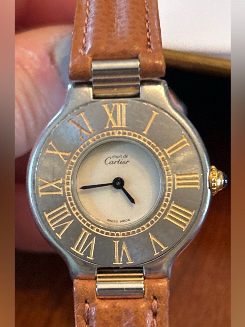 Cartier two-tone watch with gold roman accents and brown leather strap